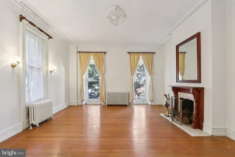 a view of a room with wooden floor and windows
