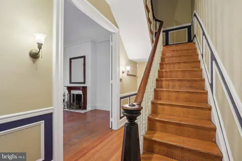 a view of empty room with wooden floor and fireplace