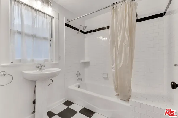 a bathroom with a sink a mirror and a bathtub