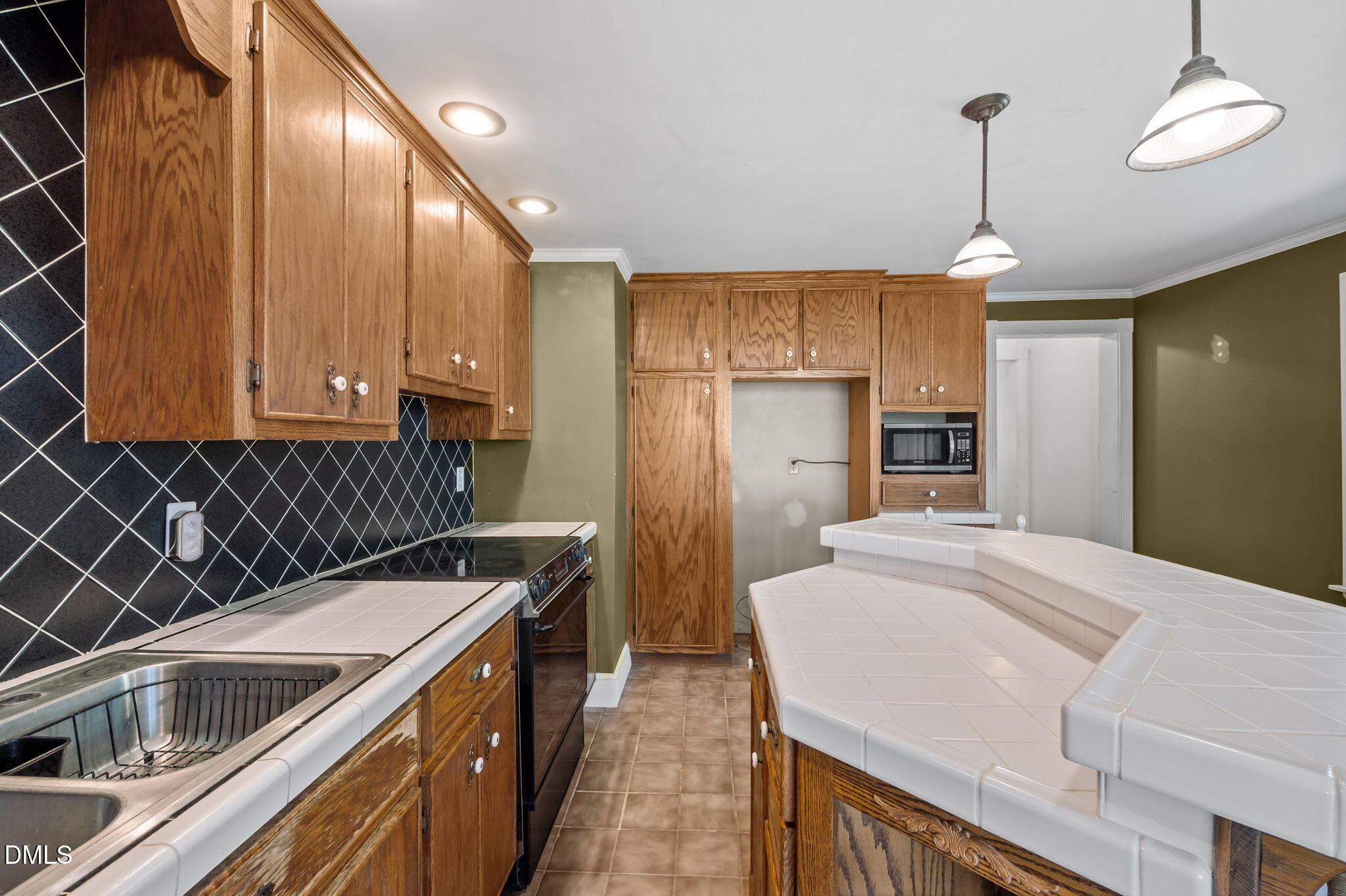 212 Thomas Humphries Road Roxboro, NC 27574 - Photo 37 of 56 a kitchen with a stove a refrigerator and a sink
