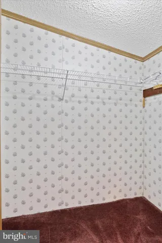 an empty room with hallway and closet