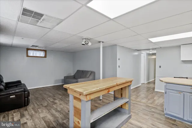 a living room with furniture and a kitchen view