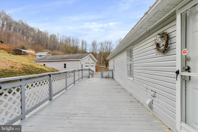 a view of a white house with a yard covered in snow