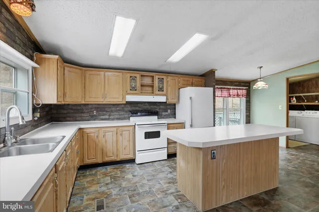a kitchen with a stove a sink and a refrigerator