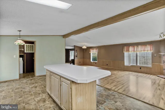 a spacious bedroom with a large bed and a dresser