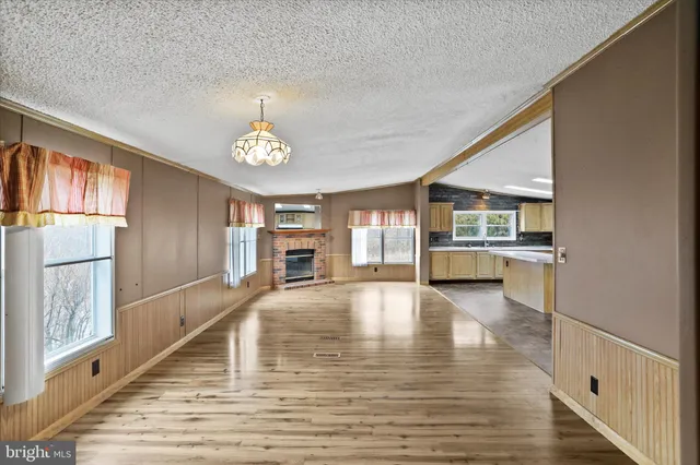 a view of a kitchen with wooden floor and a kitchen