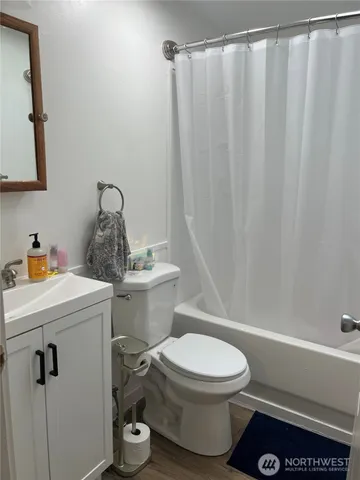a bathroom with a toilet and a shower curtain