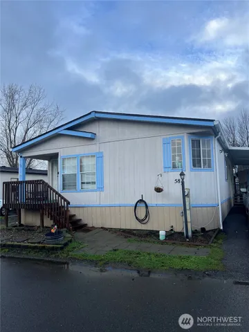 a view of a house with backyard and sitting area
