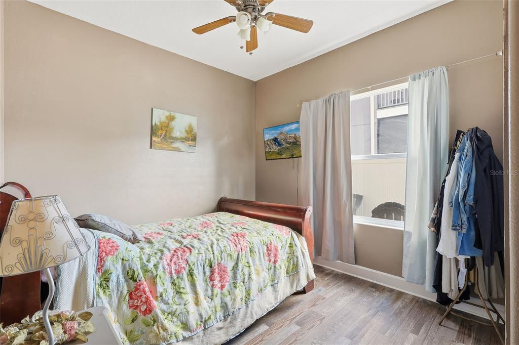 5047 Rishley Run Way Mount Dora, FL 32757 - Photo 15 of 42 a bedroom with a bed and a window
