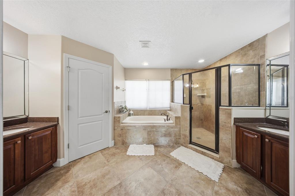 5047 Rishley Run Way Mount Dora, FL 32757 - Photo 19 of 42 a bathroom with a granite countertop sink and washing machine