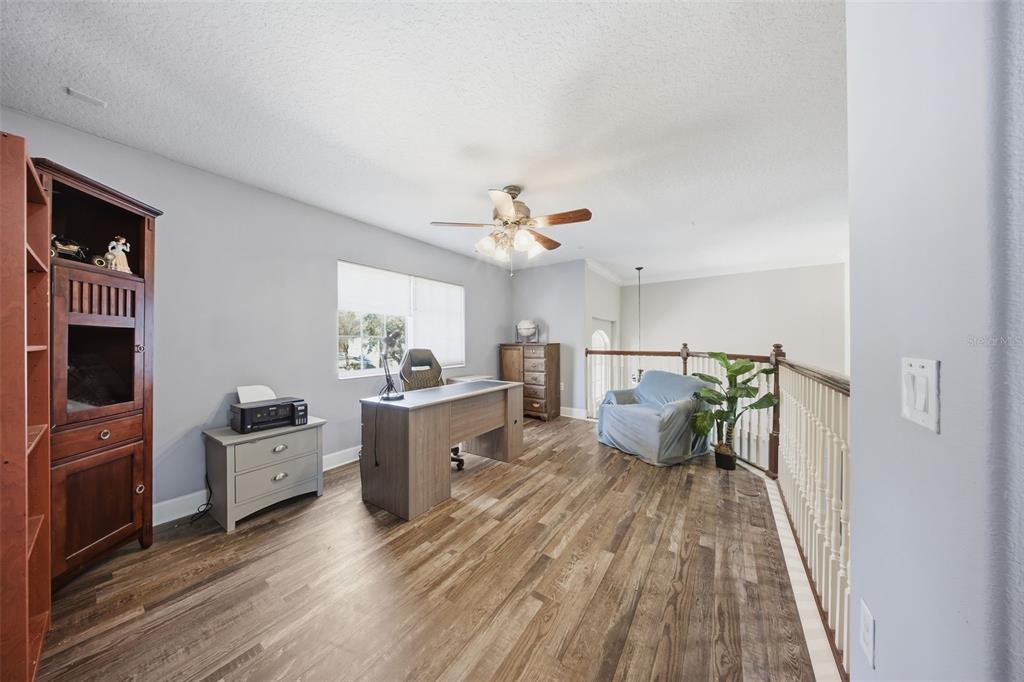 5047 Rishley Run Way Mount Dora, FL 32757 - Photo 22 of 42 a living room with furniture and wooden floor