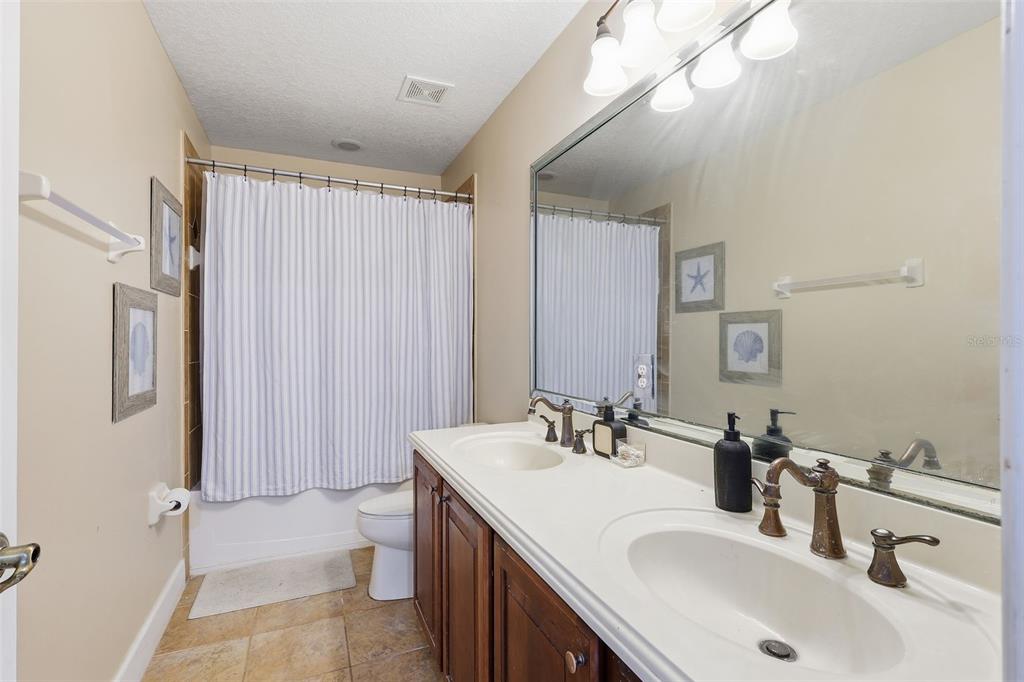 5047 Rishley Run Way Mount Dora, FL 32757 - Photo 26 of 42 a bathroom with a sink double vanity and a mirror