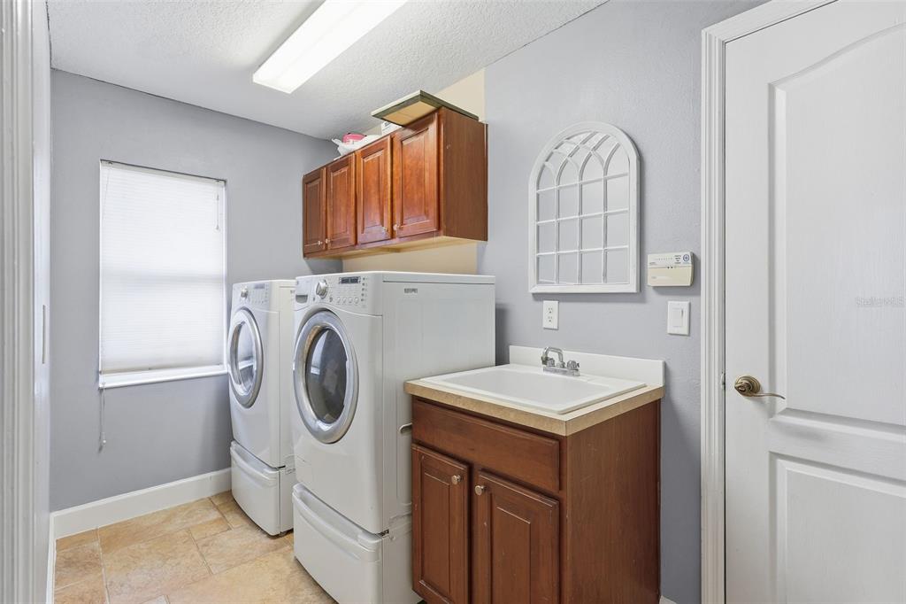 5047 Rishley Run Way Mount Dora, FL 32757 - Photo 28 of 42 a utility room with sink dryer and washer