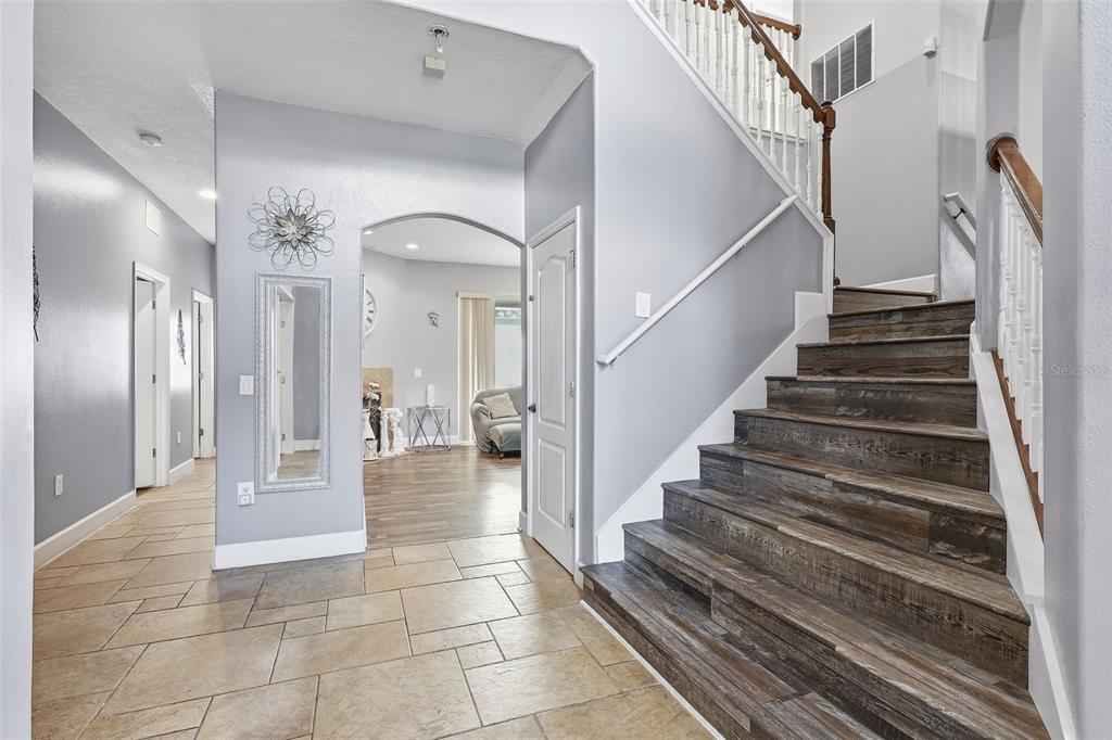 5047 Rishley Run Way Mount Dora, FL 32757 - Photo 4 of 42 a view of staircase with white walls and glass windows