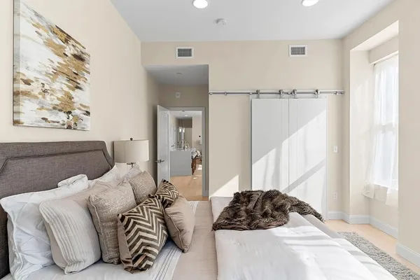 a bedroom with a bed and a window