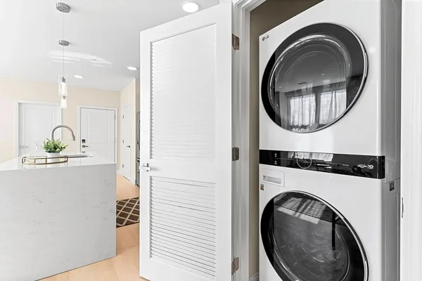 a view of a hallway with washer and dryer