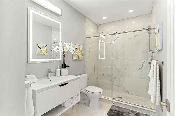 a bathroom with a toilet sink and shower