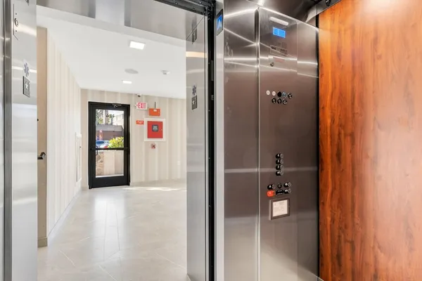 a view of a hallway with wooden shelves