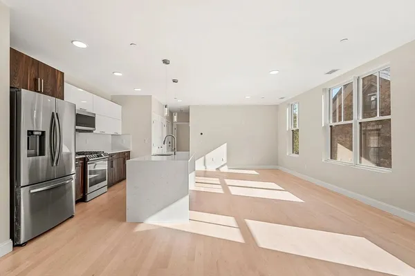a kitchen with granite countertop a refrigerator and a sink