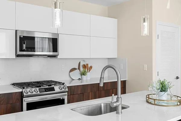 a kitchen with a stove a sink and a microwave