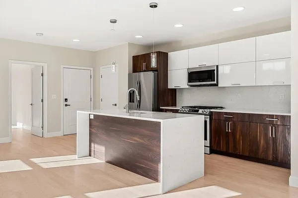a kitchen with stainless steel appliances a refrigerator and a stove top oven