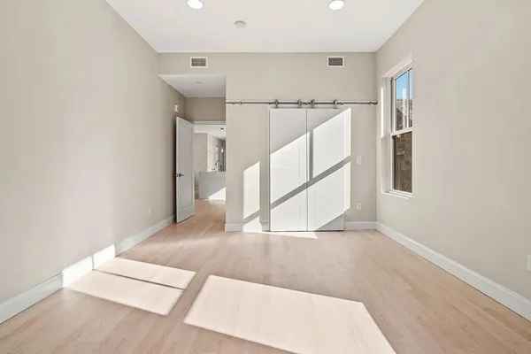 a view of entryway and hall with wooden floor