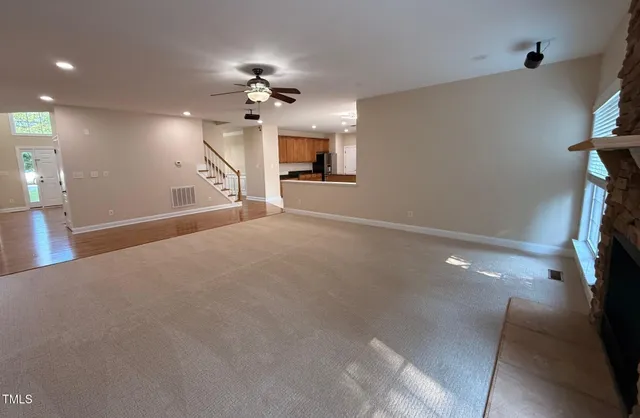 a view of a livingroom with a ceiling fan window and a chandelier