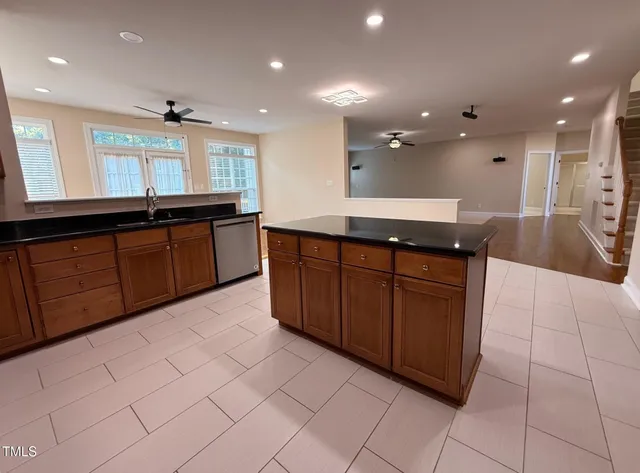 a kitchen with stainless steel appliances a refrigerator and cabinets