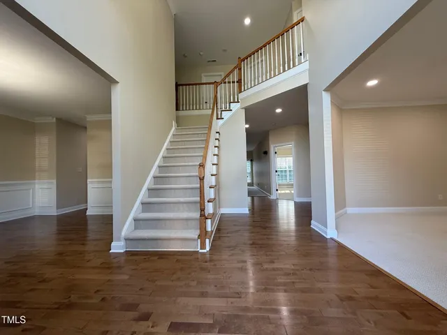 a view of a hallway with wooden floor and entryway