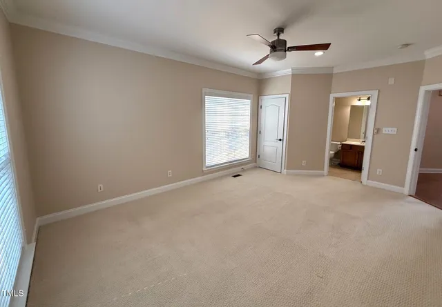 a spacious bathroom with a granite countertop sink a toilet and a mirror