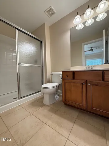 a view of empty room with window and ceiling fan
