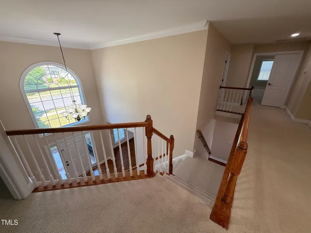 an empty room with windows and mirror