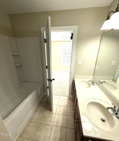 an empty room with windows and ceiling fan