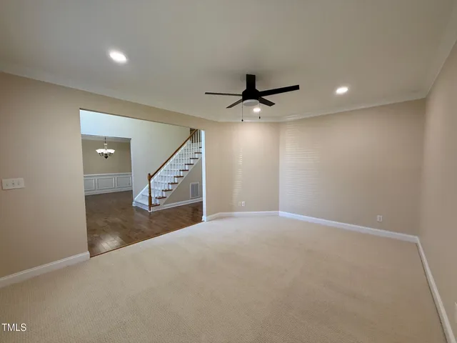 a view of a livingroom with a ceiling fan and window