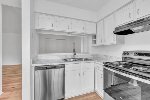 a kitchen with stainless steel appliances a refrigerator and a stove