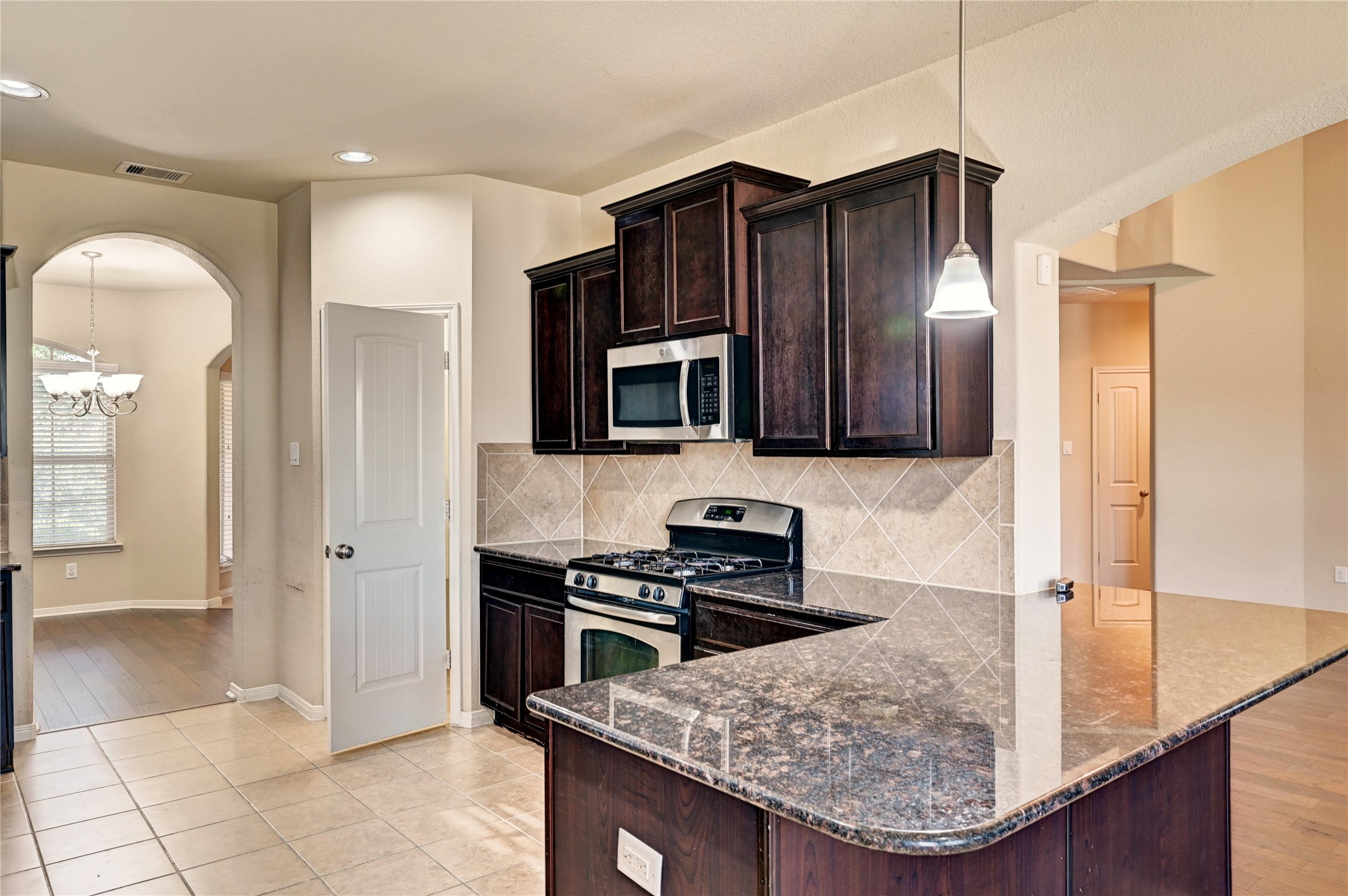 2619 Colony Haven Circle Spring, TX 77373 - Photo 23 of 50 a kitchen with stainless steel appliances granite countertop a stove a sink and a microwave