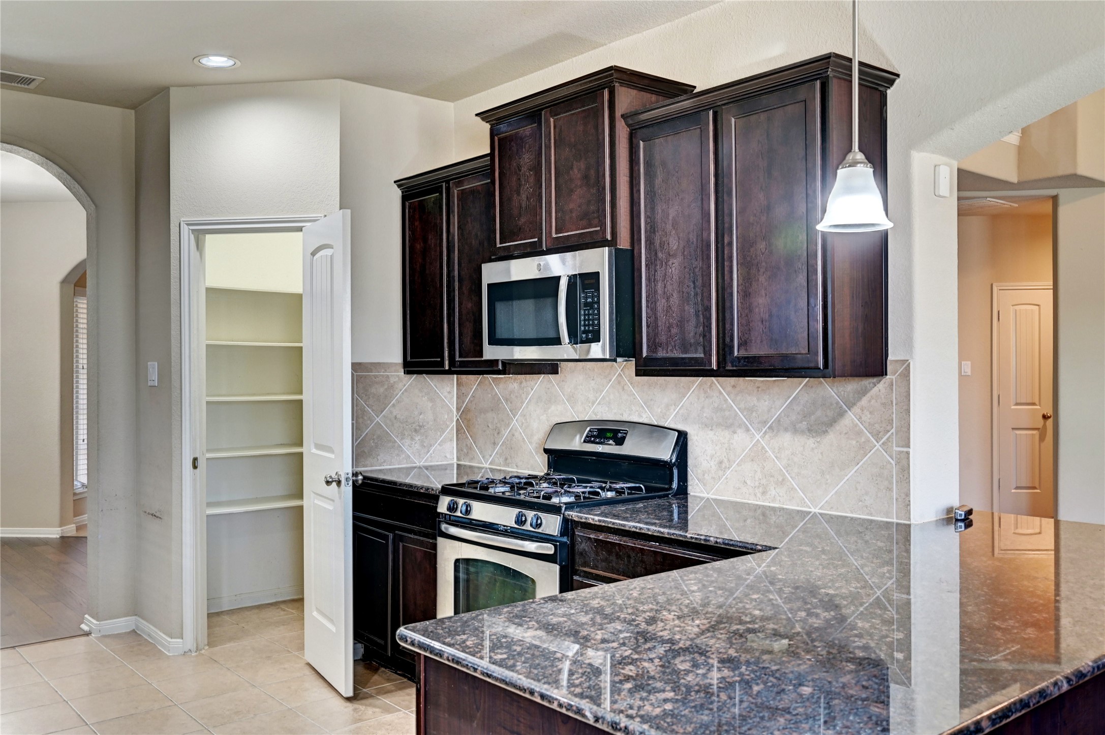 2619 Colony Haven Circle Spring, TX 77373 - Photo 24 of 50 a kitchen with wooden cabinets and stainless steel appliances