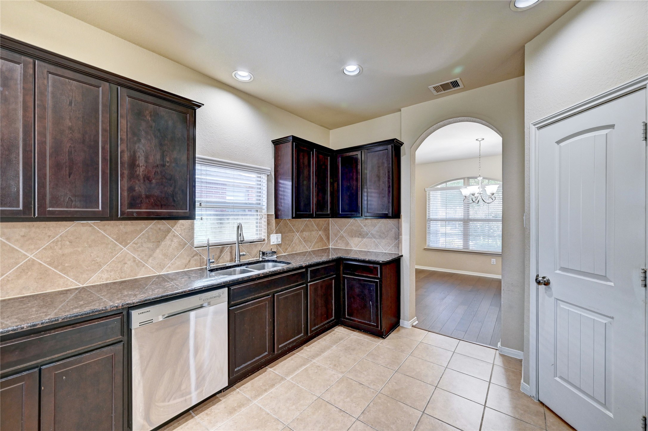 2619 Colony Haven Circle Spring, TX 77373 - Photo 26 of 50 a kitchen with stainless steel appliances granite countertop wooden cabinets a sink and dishwasher