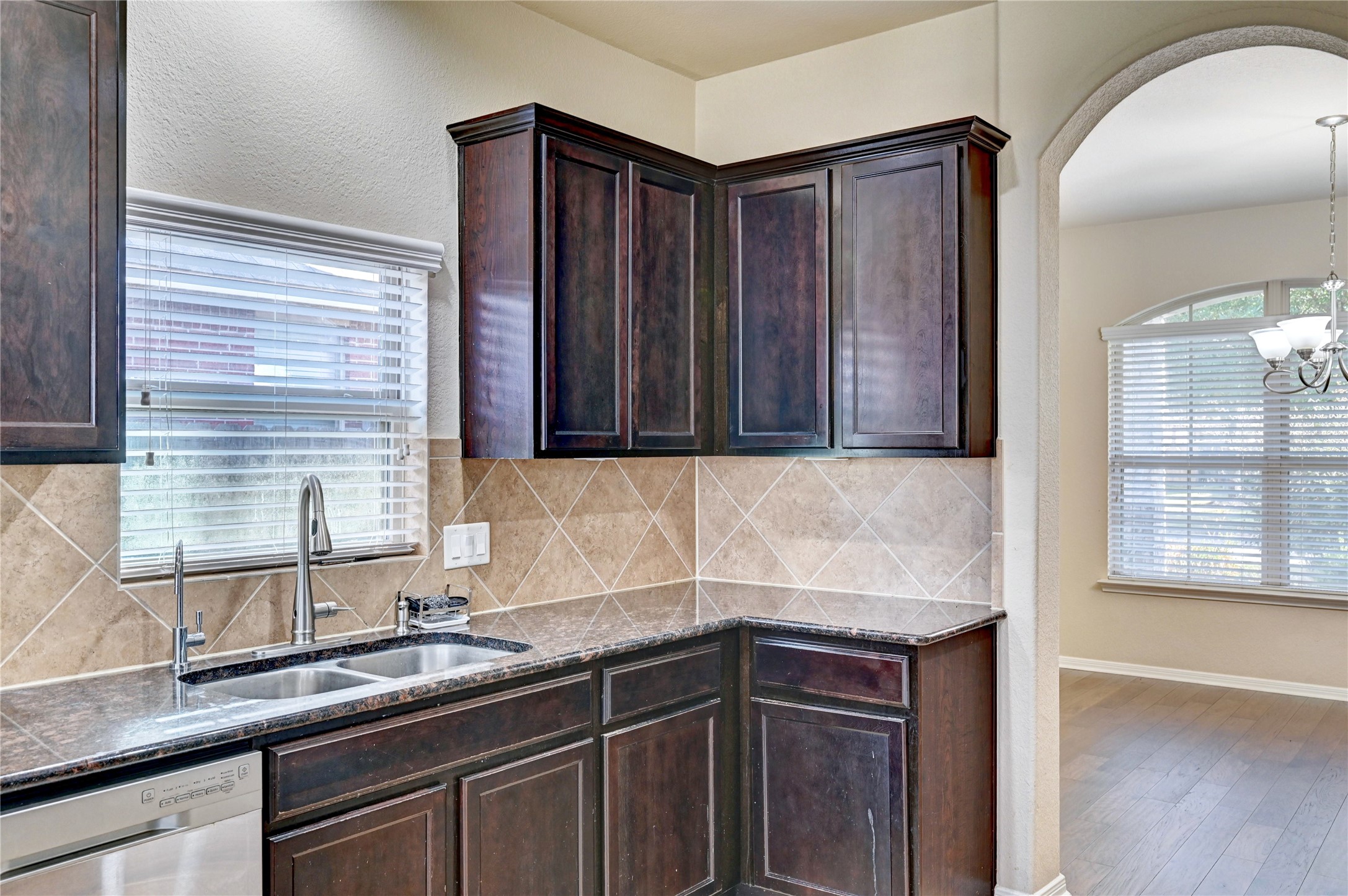 2619 Colony Haven Circle Spring, TX 77373 - Photo 27 of 50 a kitchen with stainless steel appliances granite countertop wooden cabinets a sink and a window