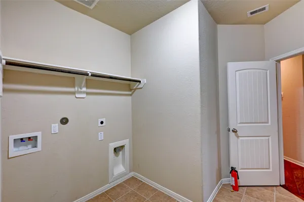 an empty room with wooden floor and chandelier fan
