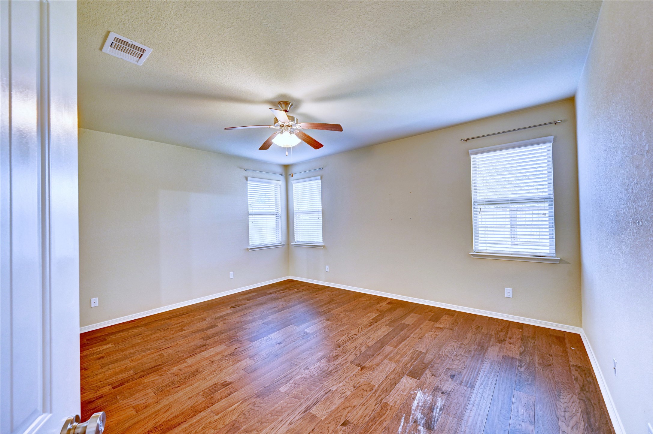 2619 Colony Haven Circle Spring, TX 77373 - Photo 32 of 50 an empty room with wooden floor and chandelier fan