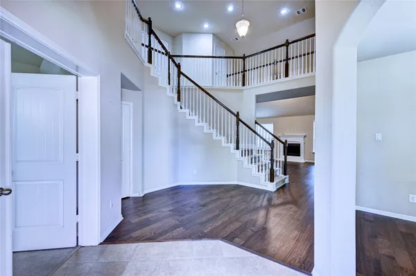 a view of entryway and hall with wooden floor