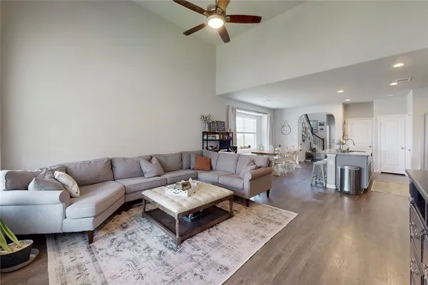 a living room with furniture and view of kitchen
