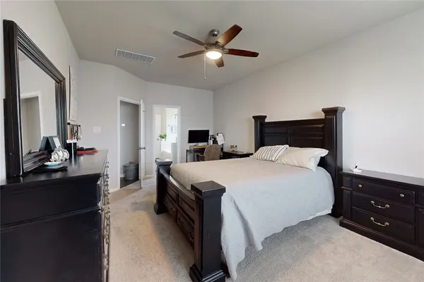 a bedroom with a bed and a dresser