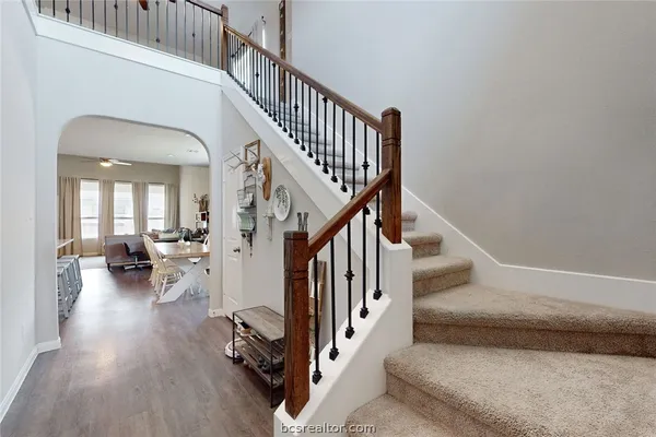 a view of entryway and hall with wooden floor
