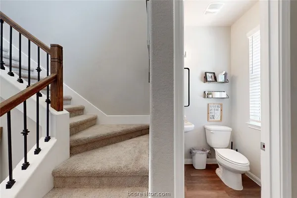 a white toilet sitting next to a bathroom sink