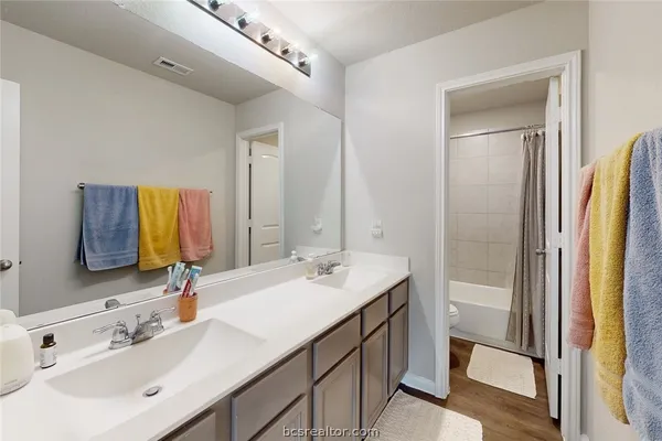 a bathroom with a double vanity sink mirror and