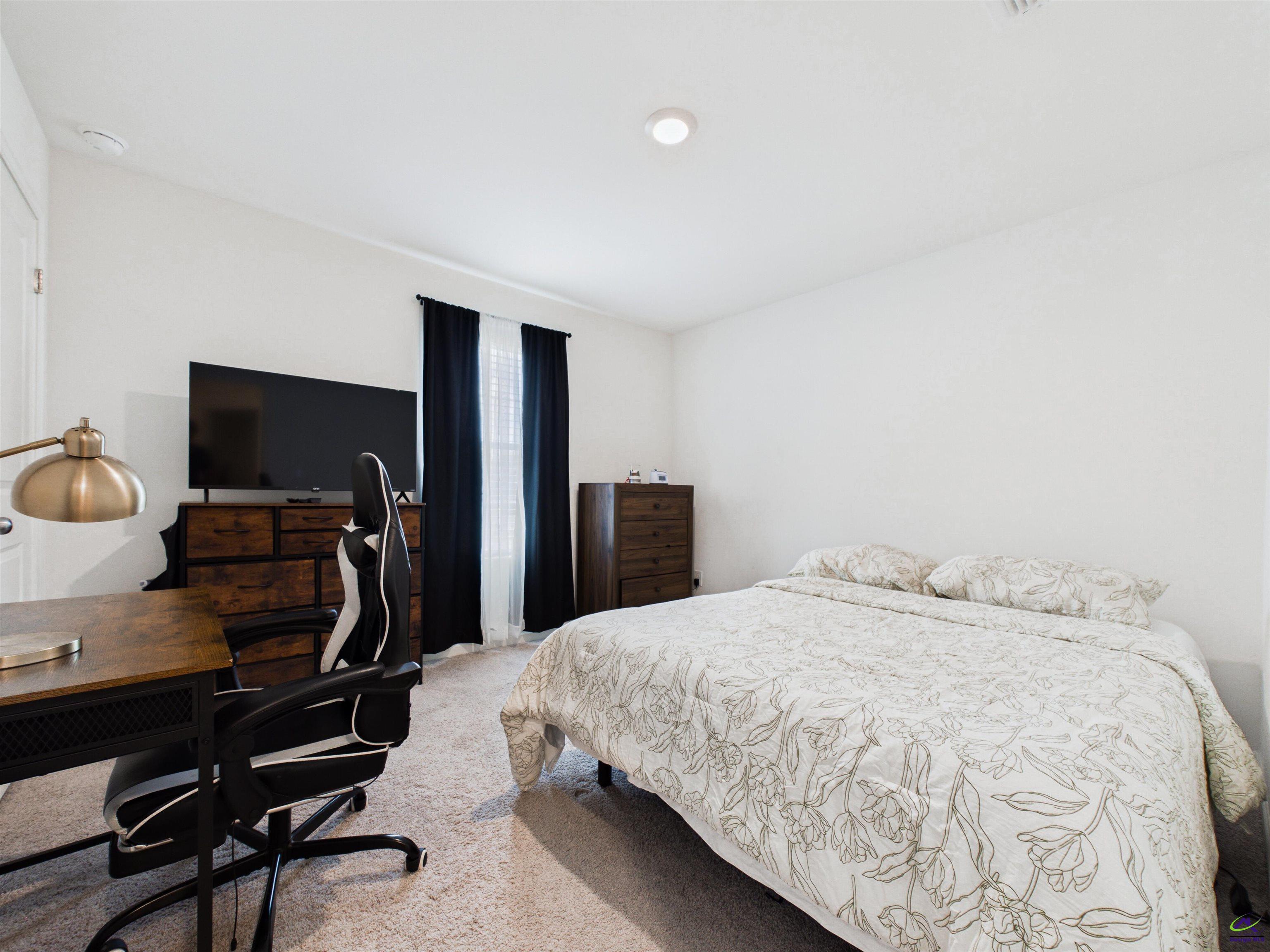 116 Jamie Court Fort Valley, GA 31030 - Photo 14 of 19 a bedroom with a bed and a flat screen tv