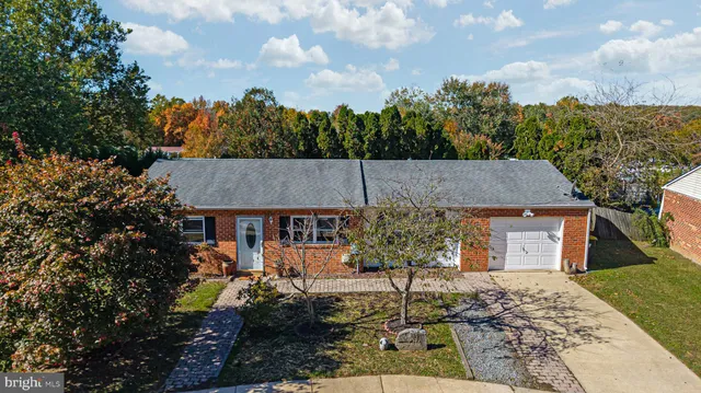 a aerial view of a house with a porch and a yard