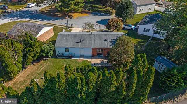 a view of house with a yard and swimming pool